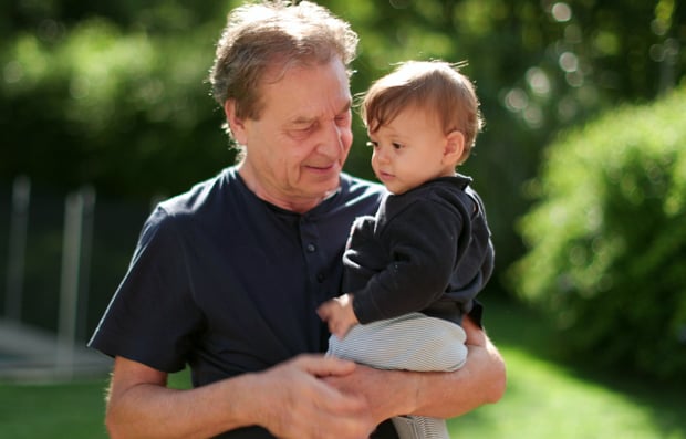 Individual holding their grandchild.