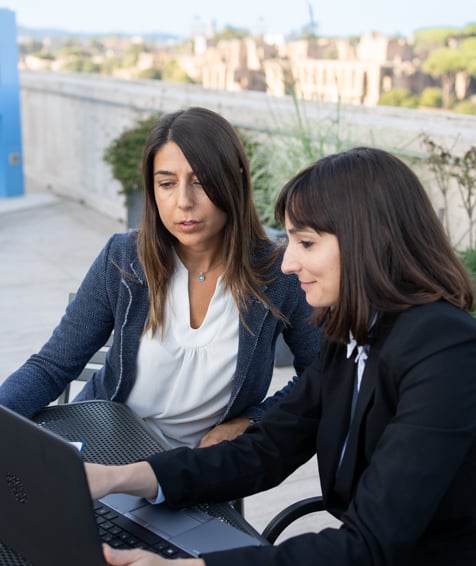 Two UNFCU staff members collaborating on a rooftop.