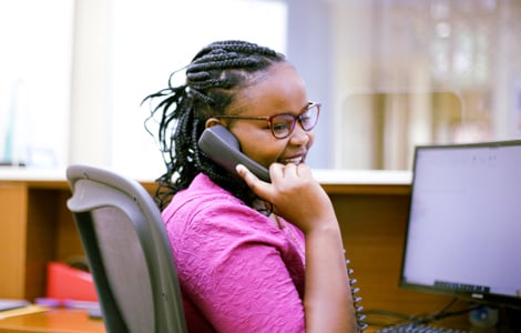 UNFCU staff member speaking on phone.