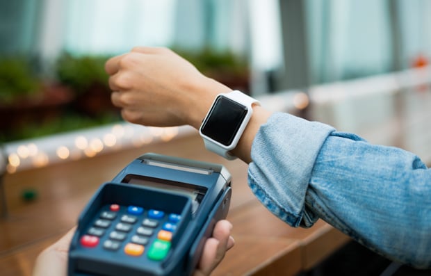 Individual using Apple watch to make a purchase.