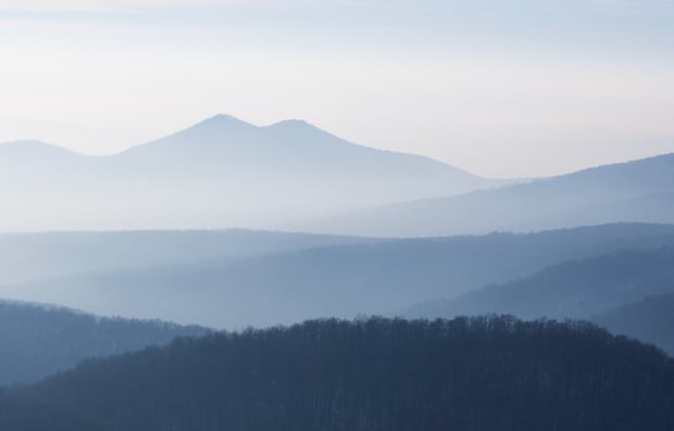 View of overlapping mountains in the distance.