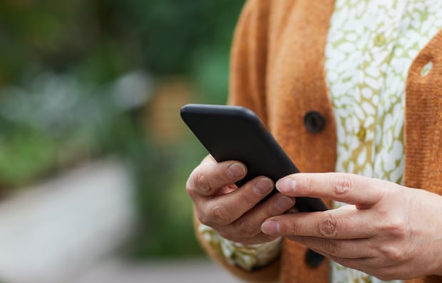 Individual looking at a cellphone.