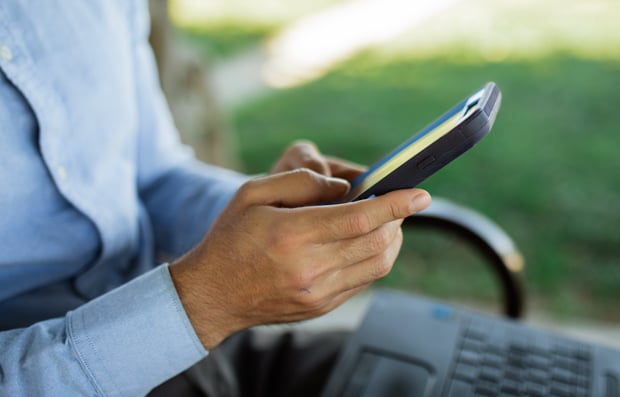 Individual looking at a cellphone.