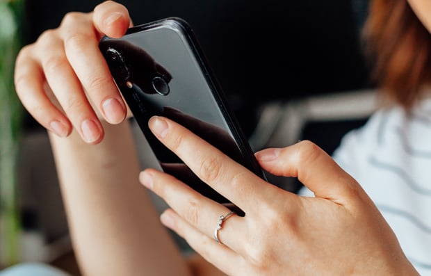 Individual looking at a cellphone.