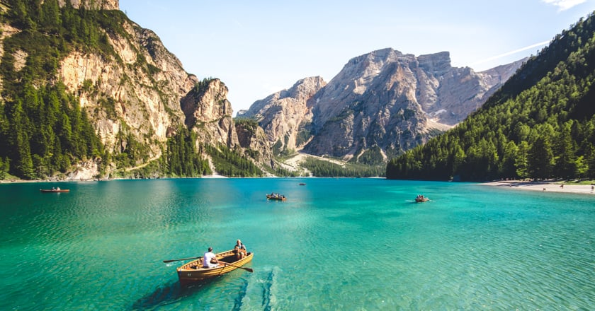 Individuals enjoying boat ride on a lake.