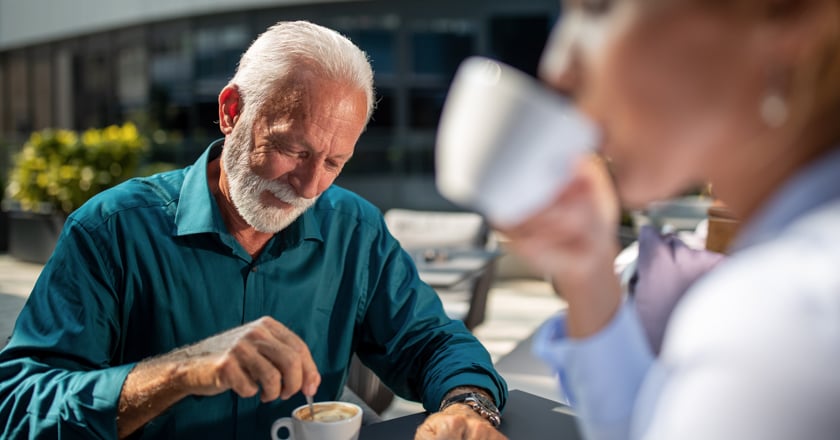 Two individuals drinking coffee