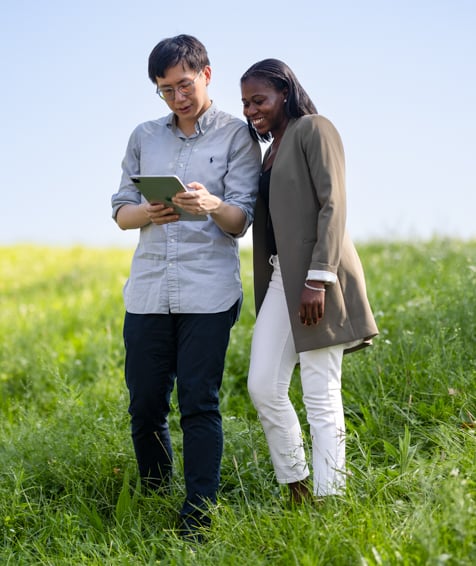 Two individuals looking at cellphone.