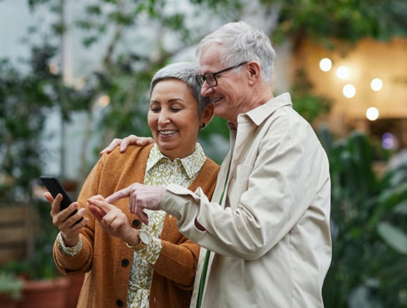 Two individuals looking at cellphone.