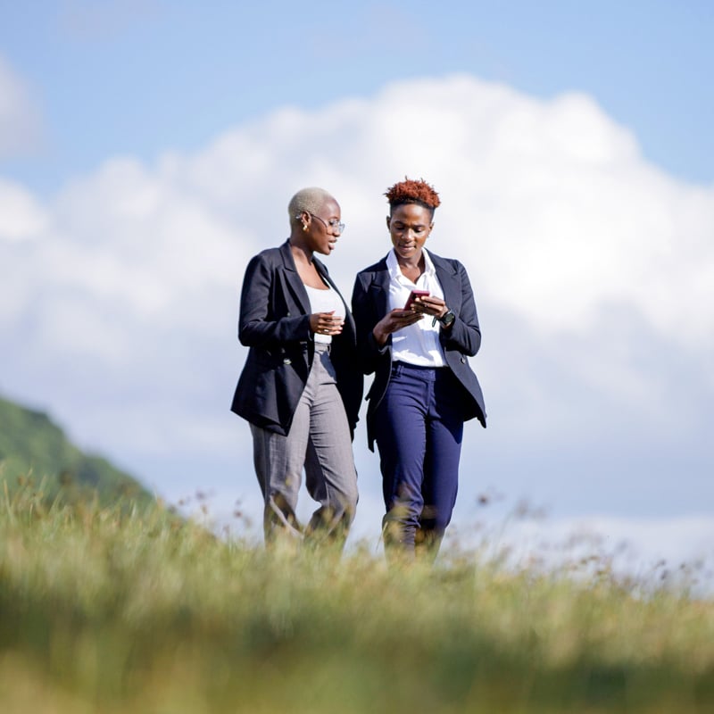 Two individuals looking at cellphone.