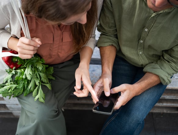 Two individuals looking at cellphone.