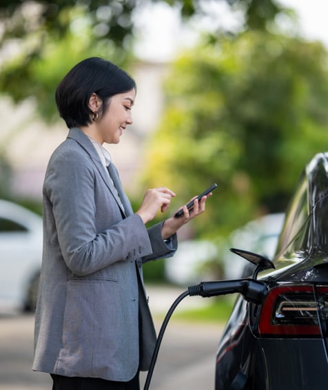 Individual charging an electric car.