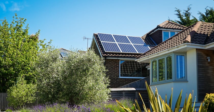 House with solar panel in nature.