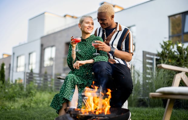 Two individuals sitting in their back yard.